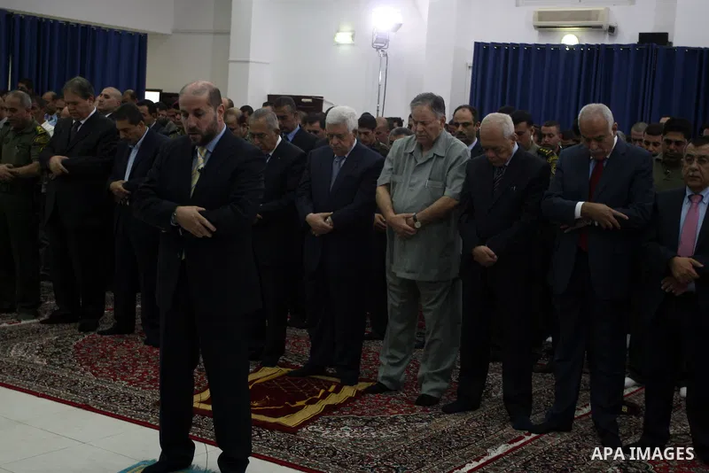 Palestinian President Mahmoud Abbas and his Prime Minister Salam Fayyad attend the early morning Eid Al-Fitr prayer at the Palestinian Authority headquarters in the West Bank city of Ramallah on Aug. 19, 2012 . Muslims o...