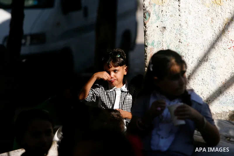 Palestinian children play with a gun toy on the Second day of Eid al-Fitr in Rafah in the southern of Gaza strip, Aug. 20, 2012. which marks the end of the Muslim fasting month of Ramadan. Eid, one of the most important...