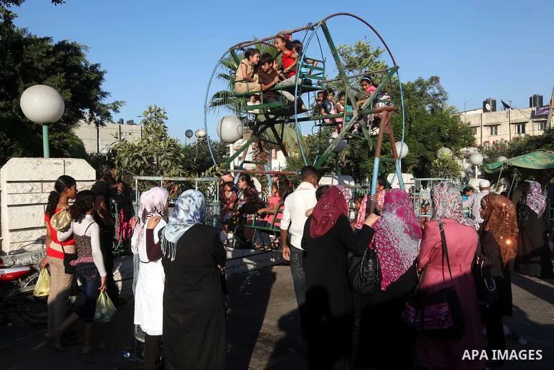 Palestinian children play at a park during the Second day of Eid al-Fitr in Gaza city, Aug. 20, 2012. which marks the end of the Muslim fasting month of Ramadan. Eid, one of the most important holidays in the Muslim worl...