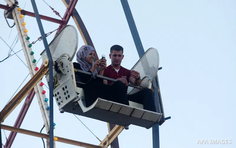 Palestinians enjoy the second day of Eid al-Fitr in an amusement park, in the West Bank city of Ramallah, Monday, Aug. 20, 2012. Eid, one of the most important holidays in the Muslim world, is marked with prayers, family...