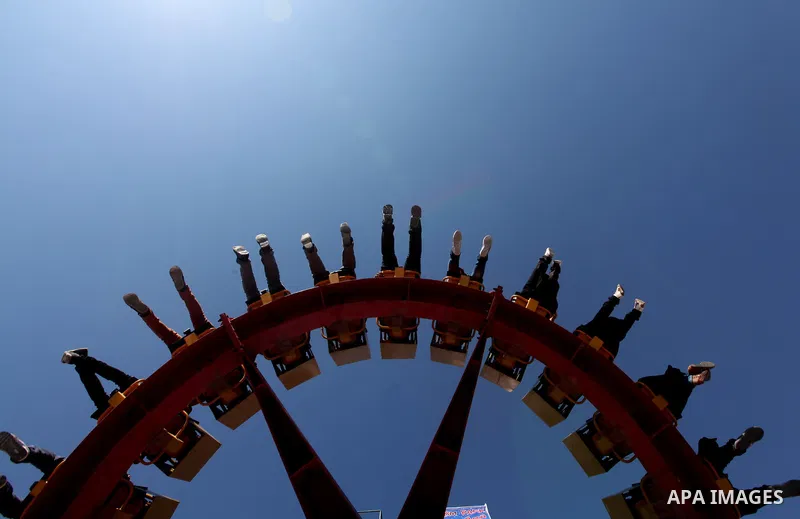 Palestinians enjoy a ride in an amusement park on the third day of Eid al-Fitr, marking the end of Islam's fasting holy month of Ramadan, in Gaza City on August 21, 2012. Photo by Majdi Fathi