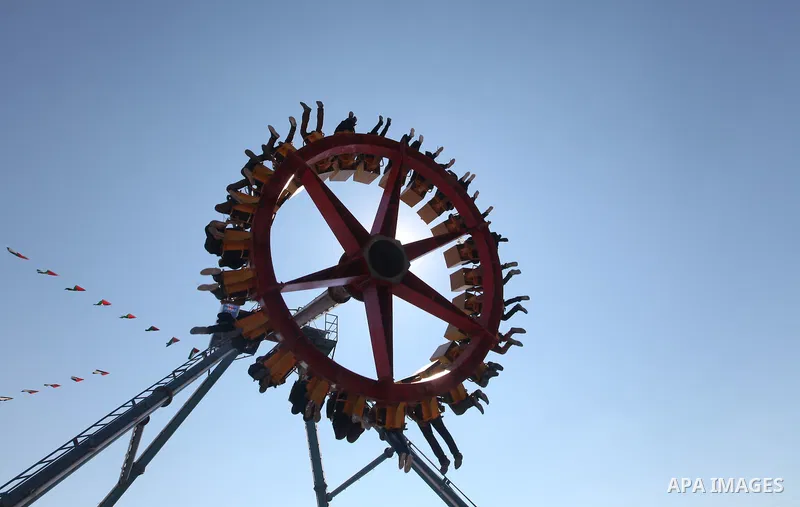 Palestinians enjoy a ride in an amusement park on the third day of Eid al-Fitr, marking the end of Islam's fasting holy month of Ramadan, in Gaza City on August 21, 2012. Photo by Majdi Fathi