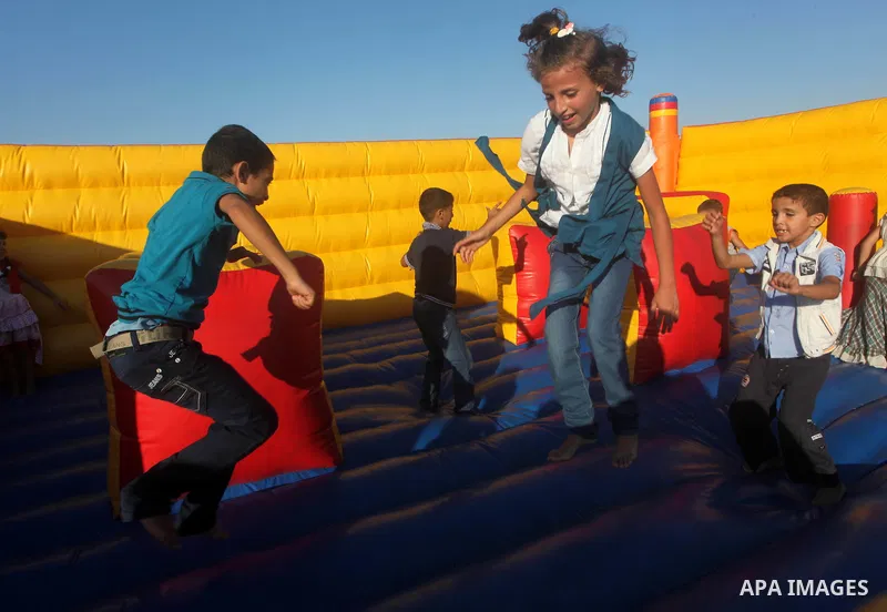 Palestinians enjoy a ride in an amusement park on the third day of Eid al-Fitr, marking the end of Islam's fasting holy month of Ramadan, in Gaza City on August 21, 2012. Photo by Ashraf Amra