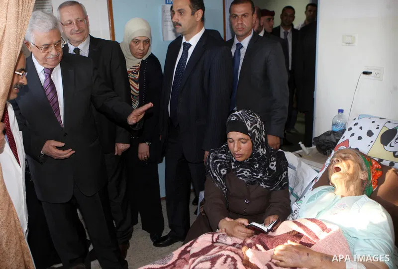 Palestinian President Mahmoud Abbas ( Abu Mazen ) visits patients in Ramallah governmental hospital in the West Bank city of Ramallah, on Aug 23, 2012. Photo by Thaer Ganaim