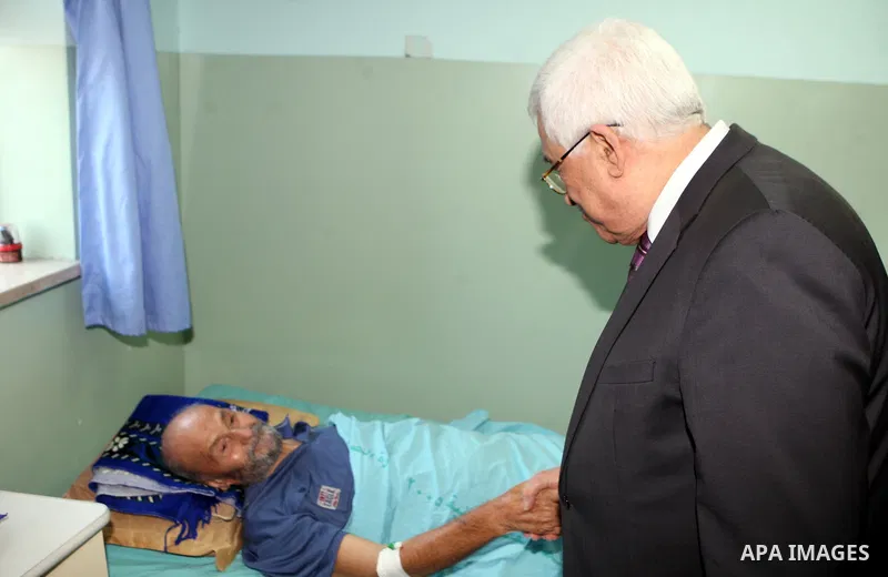 Palestinian President Mahmoud Abbas ( Abu Mazen ) visits patients in Ramallah governmental hospital in the West Bank city of Ramallah, on Aug 23, 2012. Photo by Thaer Ganaim