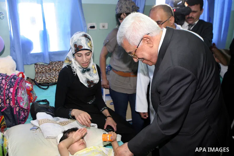 Palestinian President Mahmoud Abbas ( Abu Mazen ) visits patients in Ramallah governmental hospital in the West Bank city of Ramallah, on Aug 23, 2012. Photo by Thaer Ganaim