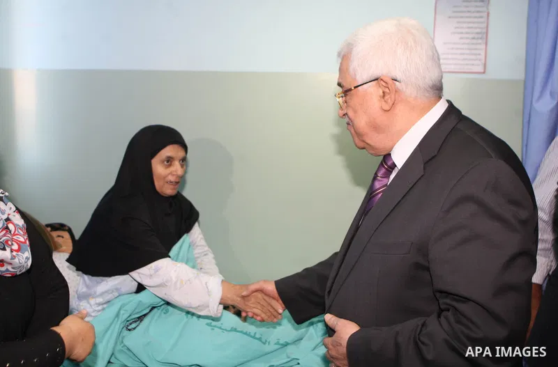 Palestinian President Mahmoud Abbas ( Abu Mazen ) visits patients in Ramallah governmental hospital in the West Bank city of Ramallah, on Aug 23, 2012. Photo by Thaer Ganaim