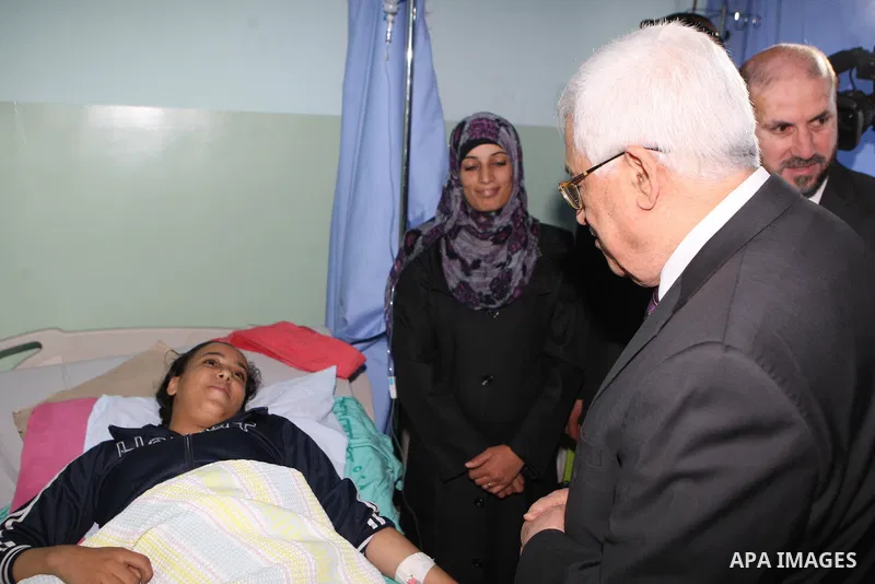 Palestinian President Mahmoud Abbas ( Abu Mazen ) visits patients in Ramallah governmental hospital in the West Bank city of Ramallah, on Aug 23, 2012. Photo by Thaer Ganaim