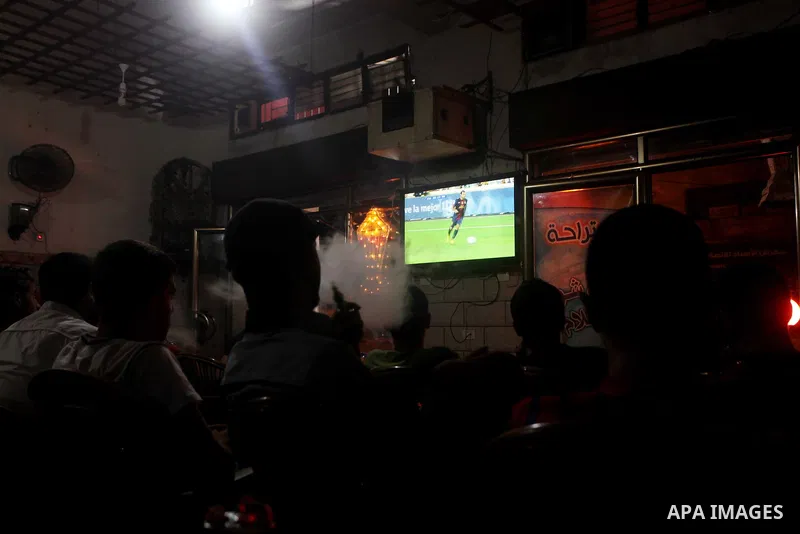 Palestinian youths watch a soccer match for FC Barcelona team against Real Madrid team during a Spanish Supercup at cafe in Deir al-Balah central Gaza Strip, on Aug 23, 2012. Photo by Ashraf Amra