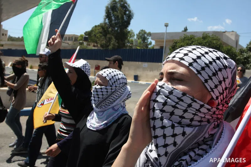 Palestinian women protest against the confiscation of Palestinian land to expand the nearby Jewish settlement of Halamish during a demonstration in the West Bank village of Nabi Saleh on August 24, 2012. The weekly demon...