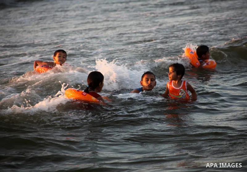 Palestinian children enjoy swimming in the sea at Gaza beach during Friday holiday in Gaza city, Aug 24, 2012. Gazans escape to the beach and out from their homes during heat wave and power outages. Photo by Ashraf Amra