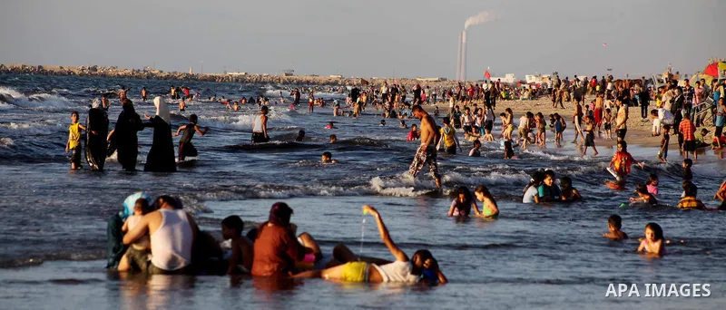 Palestinians enjoy swimming in the sea at Gaza beach during Friday holiday in Gaza city, Aug 24, 2012. Gazans escape to the beach and out from their homes during heat wave and power outages. Photo by Ashraf Amra