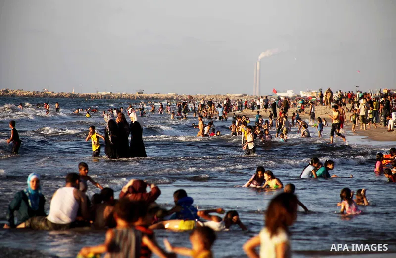 Palestinians enjoy swimming in the sea at Gaza beach during Friday holiday in Gaza city, Aug 24, 2012. Gazans escape to the beach and out from their homes during heat wave and power outages. Photo by Ashraf Amra