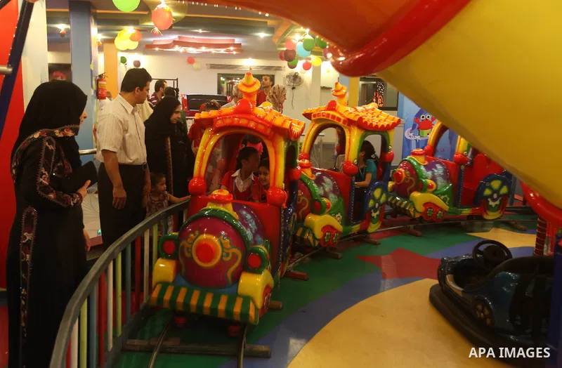 Palestinians children enjoy a ride in an amusement park, during School holidays in Gaza City, Aug. 25, 2012. Photo by Majdi Fathi