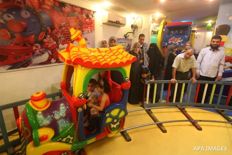 Palestinians children enjoy a ride in an amusement park, during School holidays in Gaza City, Aug. 25, 2012. Photo by Majdi Fathi