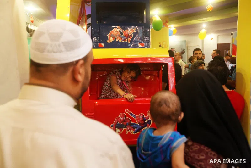 Palestinians children enjoy a ride in an amusement park, during School holidays in Gaza City, Aug. 25, 2012. Photo by Majdi Fathi
