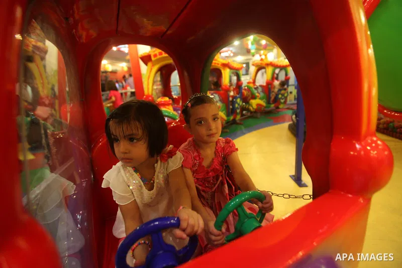 Palestinians children enjoy a ride in an amusement park, during School holidays in Gaza City, Aug. 25, 2012. Photo by Majdi Fathi