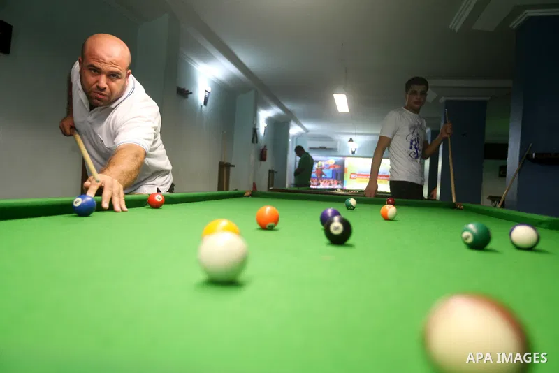 Palestinians youth enjoy billiard Games, during university holidays in Gaza City, Aug. 25, 2012. Photo by Majdi Fathi