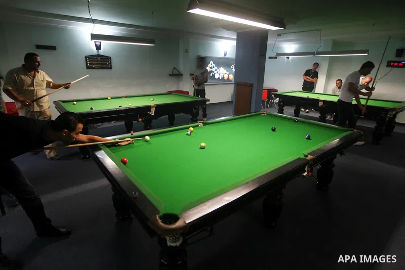 Palestinians youth enjoy billiard Games, during university holidays in Gaza City, Aug. 25, 2012. Photo by Majdi Fathi