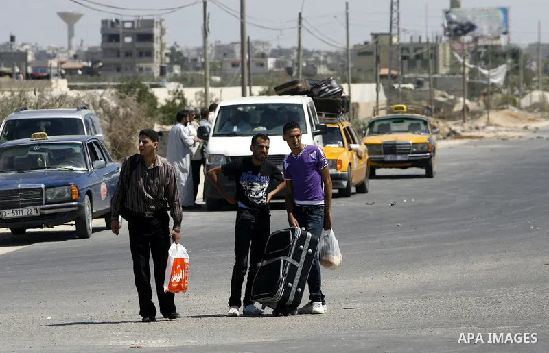 Palestinians load their luggage outside a station at the Rafah border crossing in the southern Gaza Strip before travelling to Egypt on August 25, 2012. Egypt allowed some Palestinians to enter its territory from Gaza ....