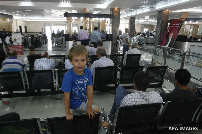 Palestinians wait inside a station at the Rafah border crossing in the southern Gaza Strip before travelling to Egypt on August 25, 2012. Egypt allowed some Palestinians to enter its territory from Gaza. Photo by Eyad Al...