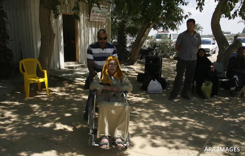 Palestinians wait outside a station at the Rafah border crossing in the southern Gaza Strip before travelling to Egypt on August 25, 2012. Egypt allowed some Palestinians to enter its territory from Gaza. Photo by Eyad A...