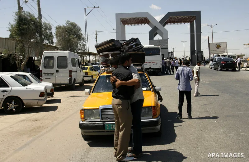 Palestinians wait outside a station at the Rafah border crossing in the southern Gaza Strip before travelling to Egypt on August 25, 2012. Egypt allowed some Palestinians to enter its territory from Gaza. Photo by Eyad A...