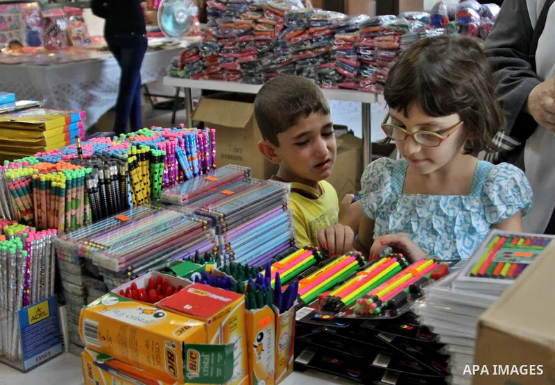Palestinians participate in the opening of an exhibition to stationery schools in the West Bank city of Nablus on Aug. 26, 2012 . Photo by Nedal Eshtayah