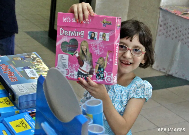 Palestinians participate in the opening of an exhibition to stationery schools in the West Bank city of Nablus on Aug. 26, 2012 . Photo by Nedal Eshtayah
