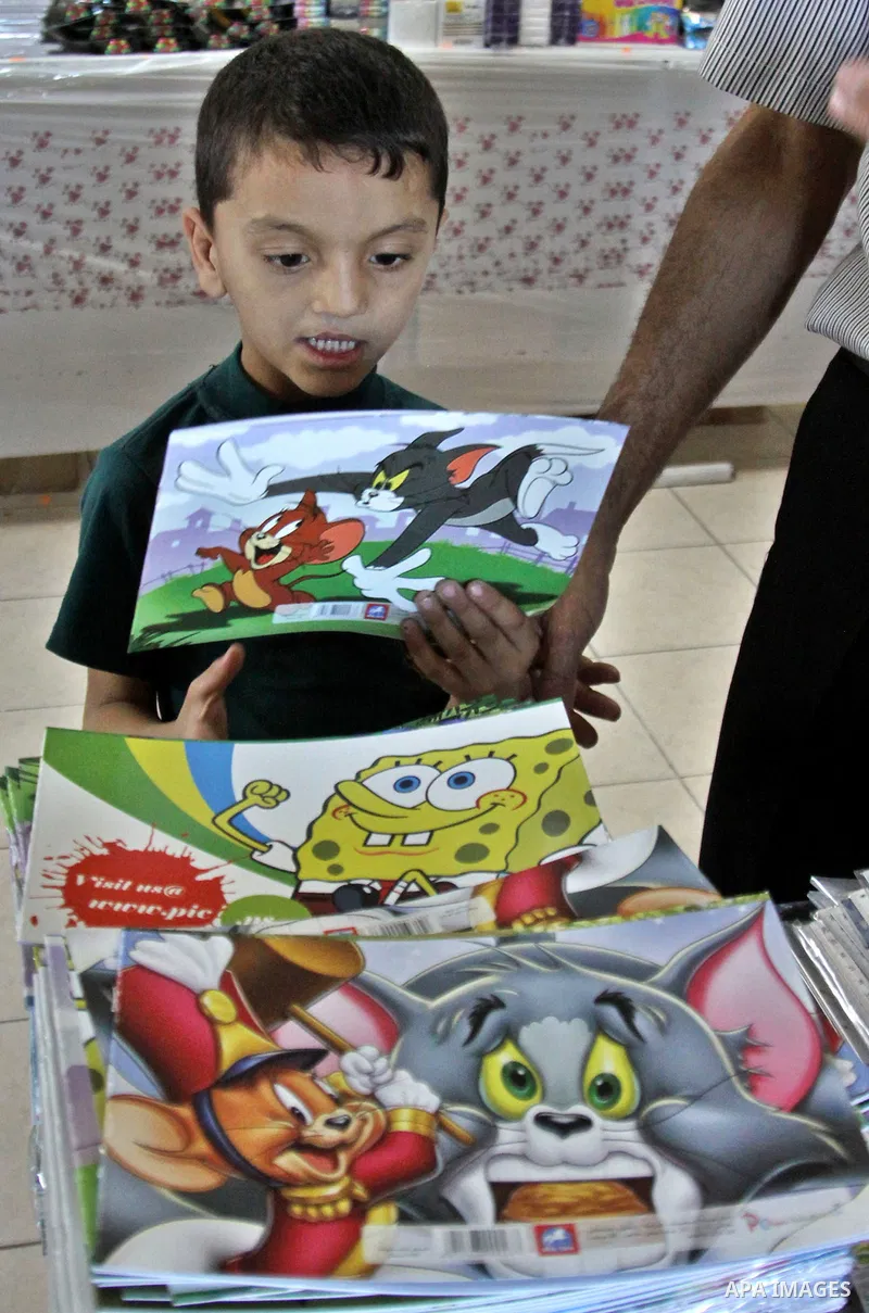 Palestinians participate in the opening of an exhibition to stationery schools in the West Bank city of Nablus on Aug. 26, 2012 . Photo by Nedal Eshtayah