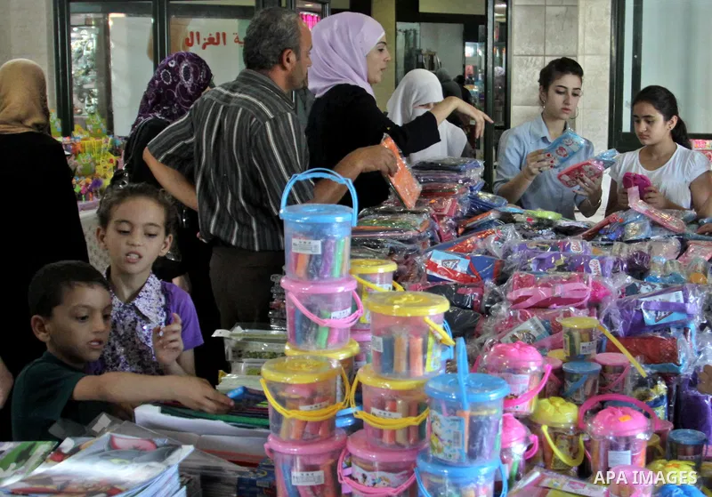 Palestinians participate in the opening of an exhibition to stationery schools in the West Bank city of Nablus on Aug. 26, 2012 . Photo by Nedal Eshtayah