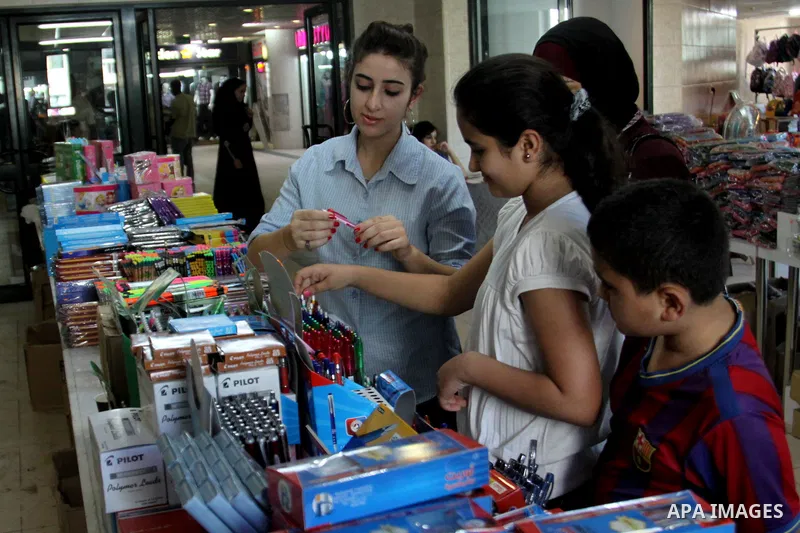 Palestinians participate in the opening of an exhibition to stationery schools in the West Bank city of Nablus on Aug. 26, 2012 . Photo by Nedal Eshtayah
