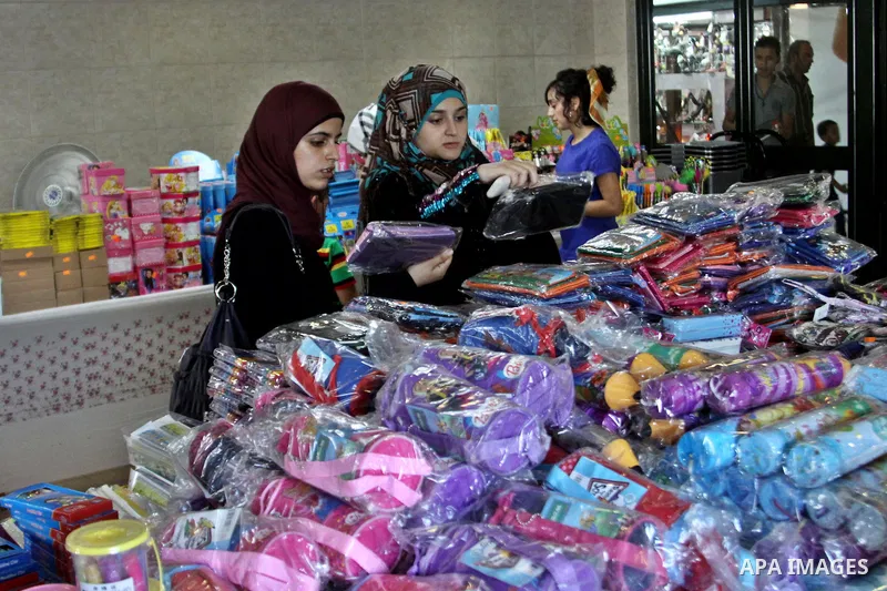 Palestinians participate in the opening of an exhibition to stationery schools in the West Bank city of Nablus on Aug. 26, 2012 . Photo by Nedal Eshtayah