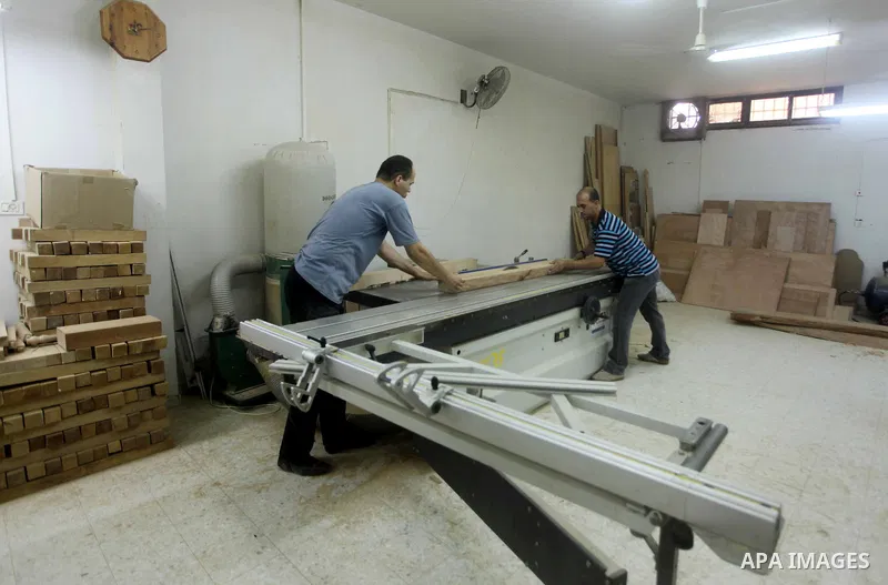 Deaf Palestinian men work on joinery at Atfaluna Society for Deaf Children in Gaza City, on Aug. 26, 2012. The society provides services for about 15,000 deaf youth on education, training programs and income generating p...