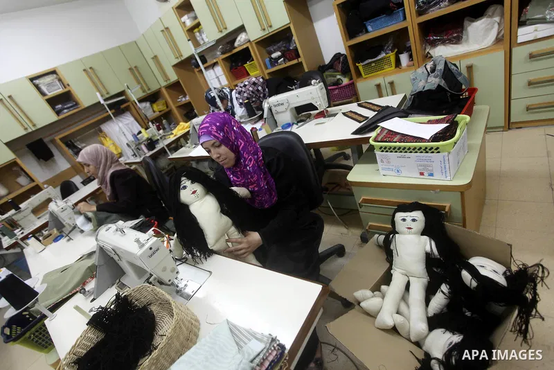 Deaf Palestinian women work on embroidery at Atfaluna Society for Deaf Children in Gaza City, on Aug. 26, 2012. The society provides services for about 15,000 deaf youth on education, training programs and income generat...