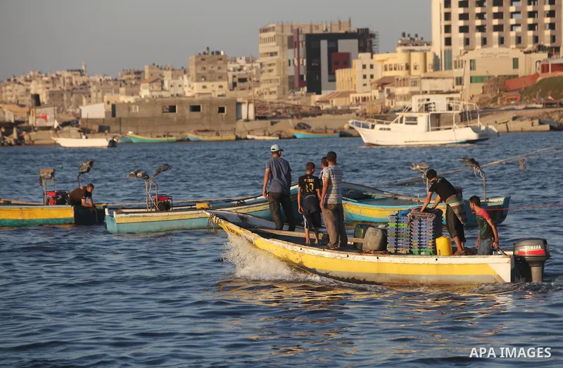 Palestinian fishermen work on their boats at the port of Gaza city on Aug 26, 2012. The ship Estelle, which leads the Freedom Flotilla will reach the Gaza port from San Sebastian, Basque Country, northern Spain within da...