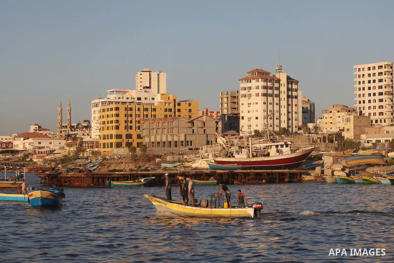 Palestinian fishermen work on their boats at the port of Gaza city on Aug 26, 2012. The ship Estelle, which leads the Freedom Flotilla will reach the Gaza port from San Sebastian, Basque Country, northern Spain within da...