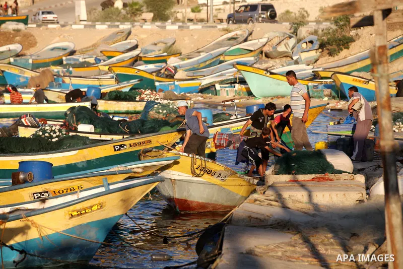 Palestinian fishermen work on their boats at the port of Gaza city on Aug 26, 2012. The ship Estelle, which leads the Freedom Flotilla will reach the Gaza port from San Sebastian, Basque Country, northern Spain within da...