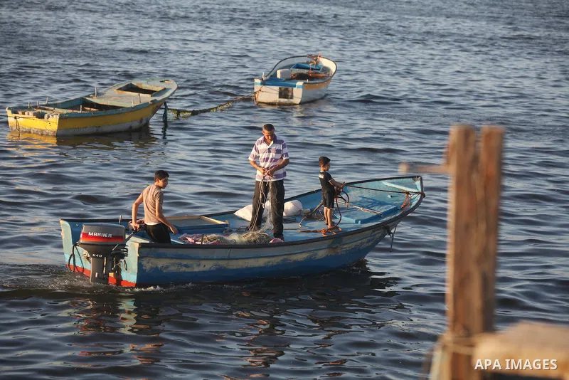 Palestinian fishermen work on their boats at the port of Gaza city on Aug 26, 2012. The ship Estelle, which leads the Freedom Flotilla will reach the Gaza port from San Sebastian, Basque Country, northern Spain within da...