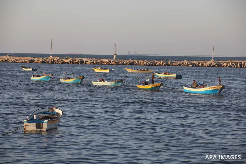 Palestinian fishermen work on their boats at the port of Gaza city on Aug 26, 2012. The ship Estelle, which leads the Freedom Flotilla will reach the Gaza port from San Sebastian, Basque Country, northern Spain within da...