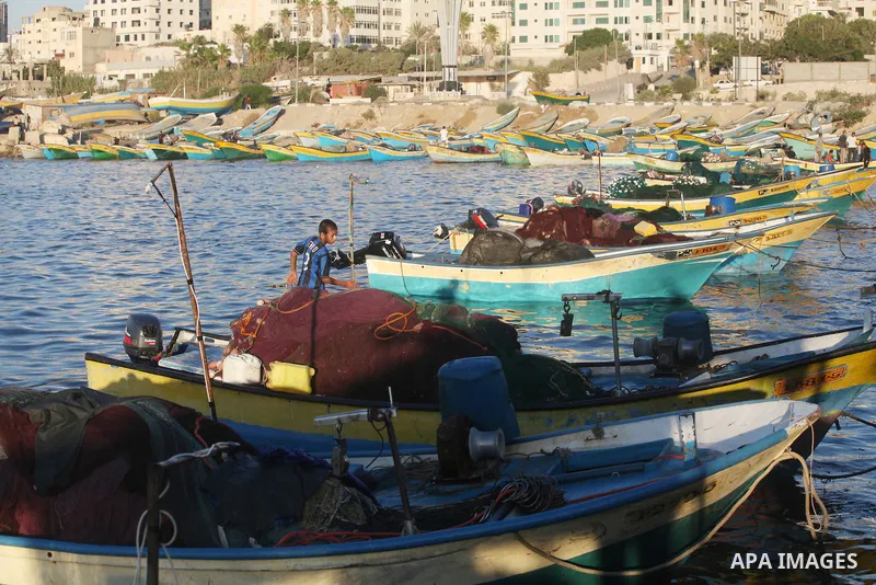 Palestinian fishermen work on their boats at the port of Gaza city on Aug 26, 2012. The ship Estelle, which leads the Freedom Flotilla will reach the Gaza port from San Sebastian, Basque Country, northern Spain within da...