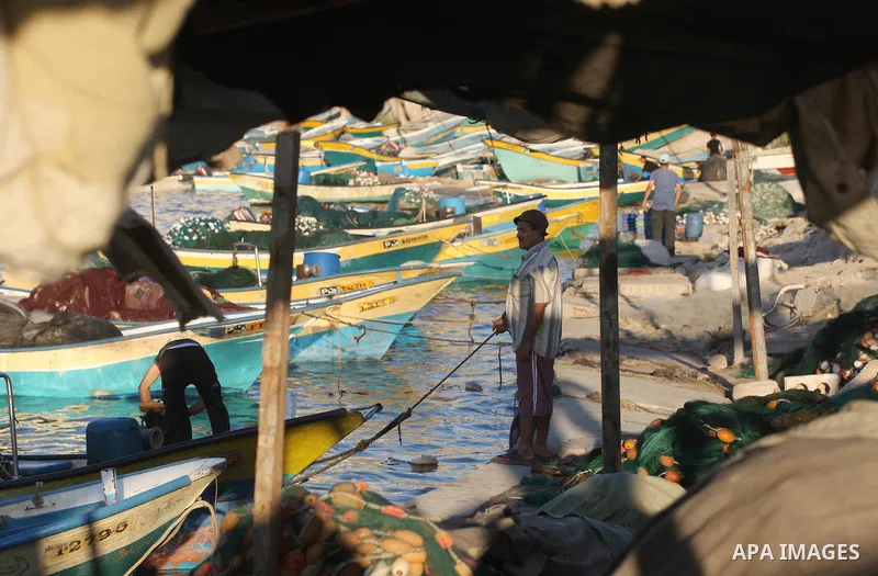 Palestinian fishermen work on their boats at the port of Gaza city on Aug 26, 2012. The ship Estelle, which leads the Freedom Flotilla will reach the Gaza port from San Sebastian, Basque Country, northern Spain within da...