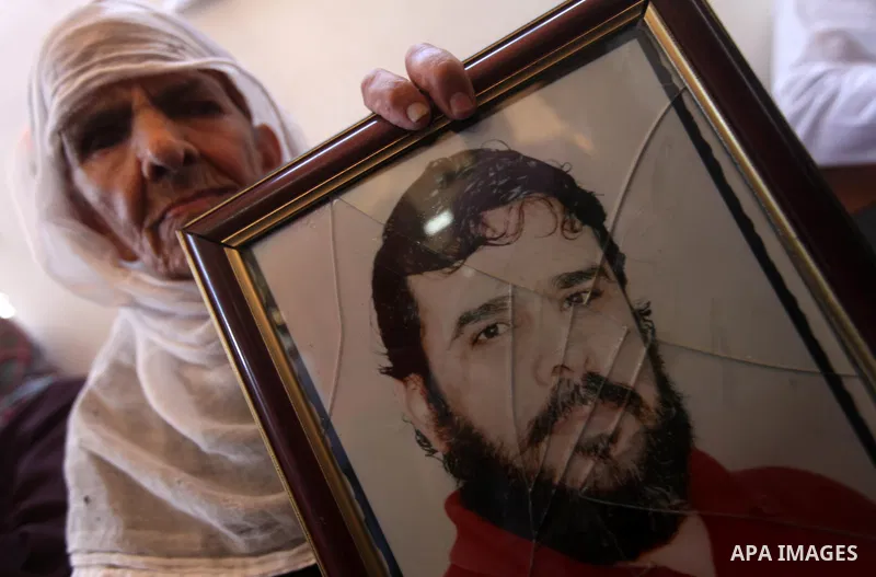Palestinians hold pictures of their relatives prisoners in Israeli jails as they gather in an activity calling for their liberty at the Red Cross headquarters in Gaza City on Aug. 27, 2012. Photo by Majdi Fathi