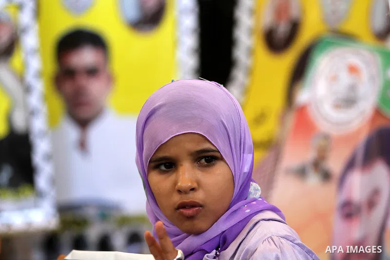 Palestinians hold pictures of their relatives prisoners in Israeli jails as they gather in an activity calling for their liberty at the Red Cross headquarters in Gaza City on Aug. 27, 2012. Photo by Majdi Fathi