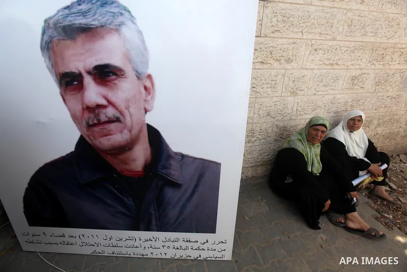 Palestinians hold pictures of their relatives prisoners in Israeli jails as they gather in an activity calling for their liberty at the Red Cross headquarters in Gaza City on Aug. 27, 2012. Photo by Majdi Fathi