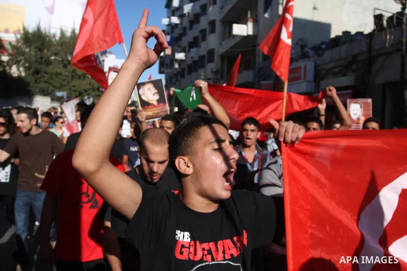 Hundreds of supporters of the Palestinian Front for the Liberation of Palestine (PFLP) shout slogans during a rally mark the 11th anniversary of the assassination of PFLP leader Abu Ali Mustafa, in the West Bank city of...