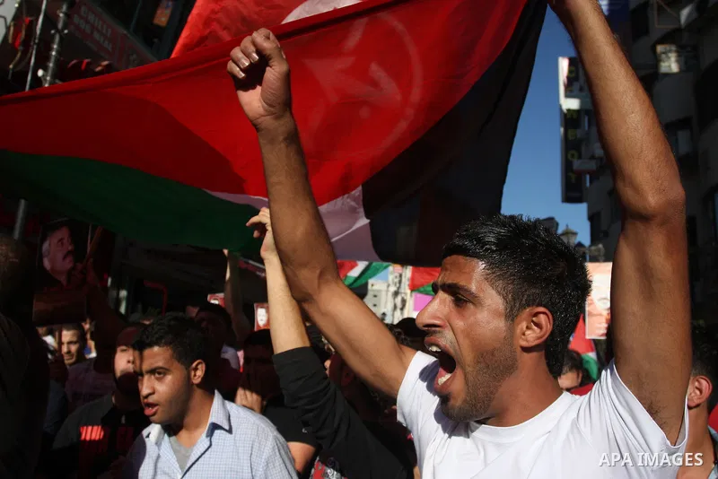 Hundreds of supporters of the Palestinian Front for the Liberation of Palestine (PFLP) shout slogans during a rally mark the 11th anniversary of the assassination of PFLP leader Abu Ali Mustafa, in the West Bank city of...