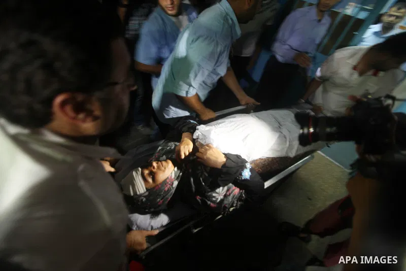 Nadia Salama Al-Rash, a wounded Palestinian women from al-Zeitoun neighborhood in Gaza city is wheeled into a hospital following an Israeli air strike on Aug 28, 2012. The Israeli air strike targeted al-Safina and Badr s...