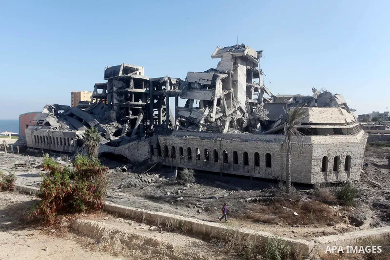 Palestinians inspect the damage at a Hamas training camp following an Israeli airstrike in Gaza City, early Tuesday, Aug. 28, 2012. Palestinian militants fired rockets towards Israel on Monday. Photo by AshrAF Amra