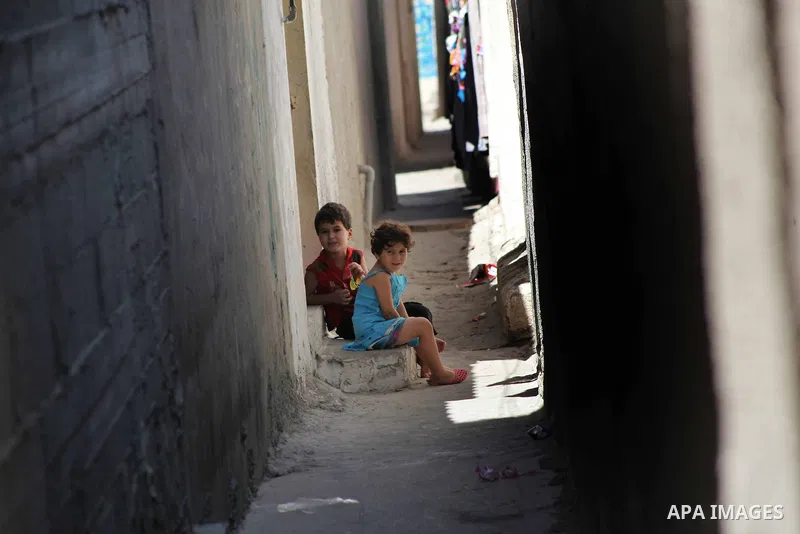 Palestinian children gather in an alley in Al-Shati refugee camp in Gaza City on August 28, 2012. Life in the poor and crowded Gaza Strip is going to get harsher still unless action is taken now, according to a new Unite...